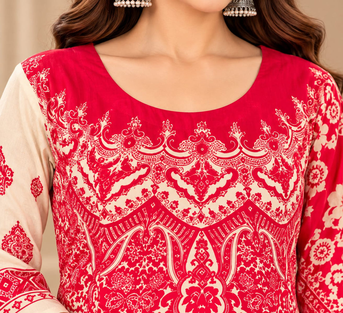 A woman models a traditional Indian salwar kameez suit set featuring a cream-colored kurta with vibrant pink embroidery, matching pink pants, and a long pink dupatta with intricate white and pink patterns, set against a warm beige background.